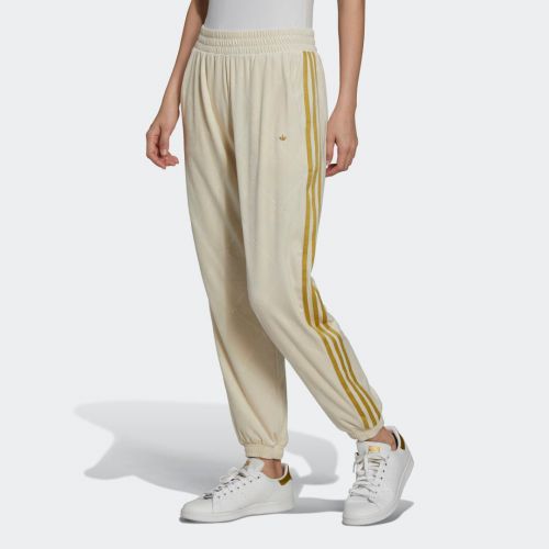 Track pants in velvet with embossed adidas originals monogram and gold stripes